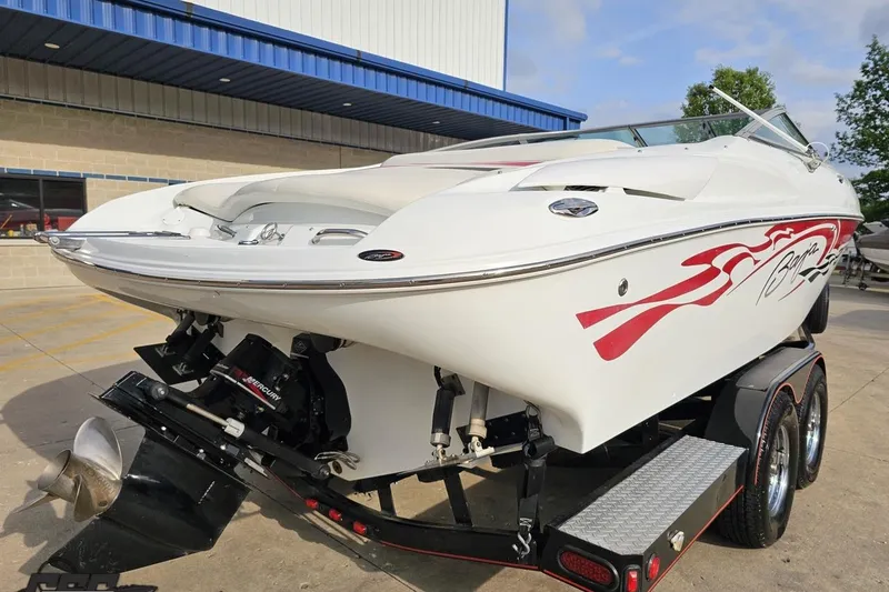 Slide: The Image of 2004 Baja 275 boat on trailer, featuring sleek white design with red accents. - 29