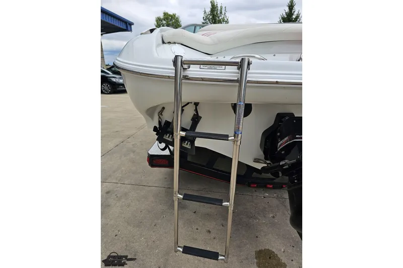 Slide: The Image of 2004 Baja 275 boat with extended swim ladder on a trailer. - 30