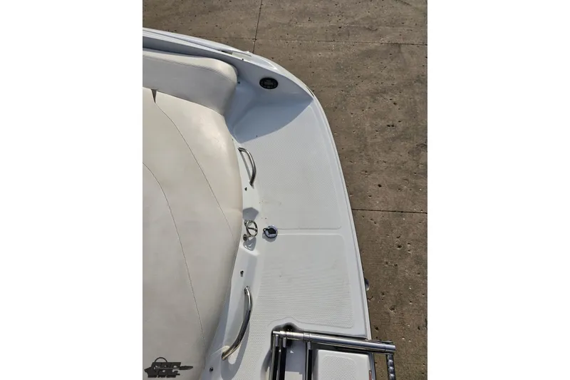 Slide: The Image of 2004 Baja 275 boat deck with white seating and stainless steel handles. - 32