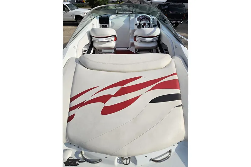 Slide: The Image of 2004 Baja 275 boat interior with white and red seating, steering wheel, and dashboard. - 34