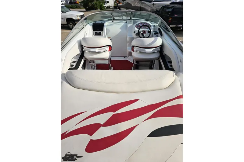 Slide: The Image of 2004 Baja 275 boat interior with white and red seating, steering wheel, and dashboard. - 35