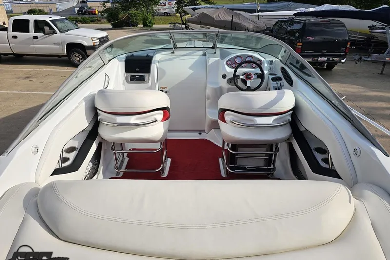 Slide: The Image of Interior of a 2004 Baja 275 boat with white seating and red accents. - 38