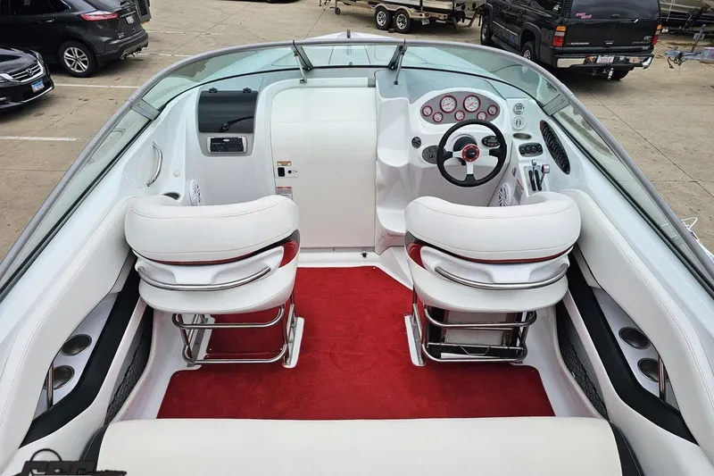 Slide: The Image of Interior of a 2004 Baja 275 boat with white seats and red carpet. - 39