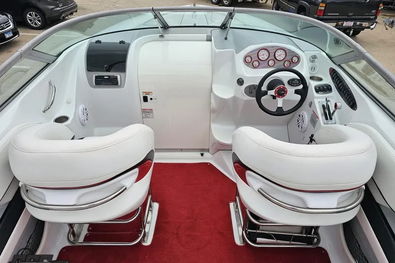 Slide: The Image of Interior of a 2004 Baja 275 boat with white seats and red carpet. - 40