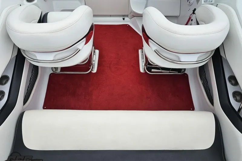 Slide: The Image of Interior of a 2004 Baja 275 boat with white seats and red carpet. - 41