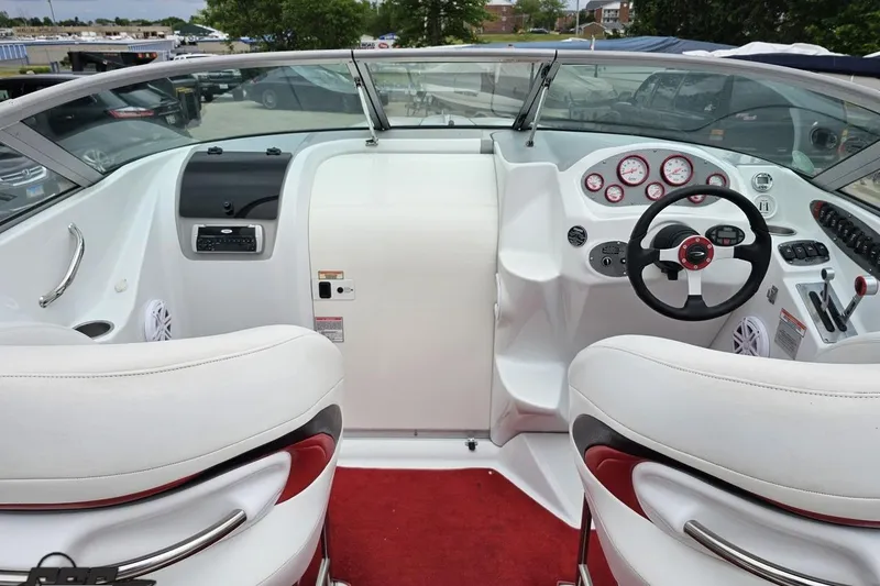 Slide: The Image of Interior of a 2004 Baja 275 boat with white seating and red accents. - 42