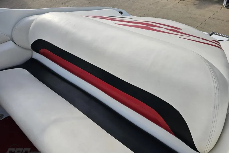 Slide: The Image of 2004 Baja 275 boat interior with white, black, and red upholstery design. - 43