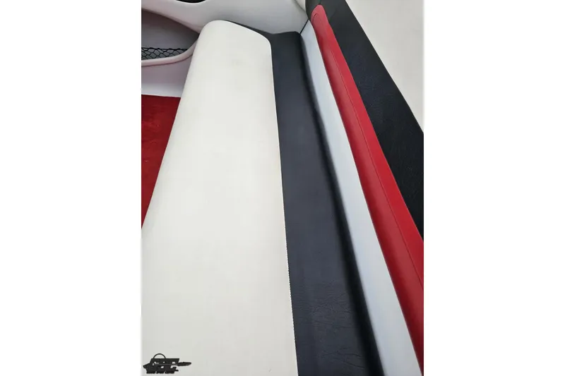 Slide: The Image of Interior seating of a 2004 Baja 275 boat with red, black, and white upholstery. - 45