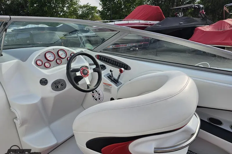 Slide: The Image of Interior of a 2004 Baja 275 boat featuring steering wheel and dashboard controls. - 46