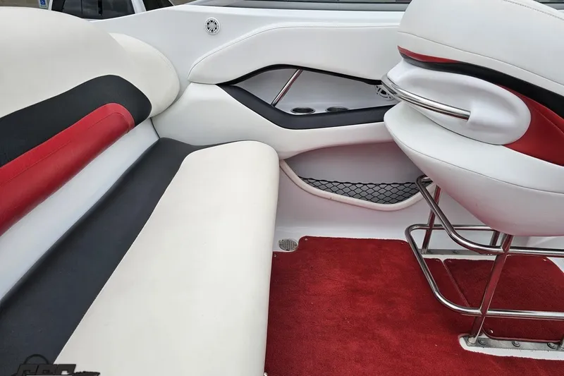 Slide: The Image of Interior of a 2004 Baja 275 boat with red and white seating. - 48