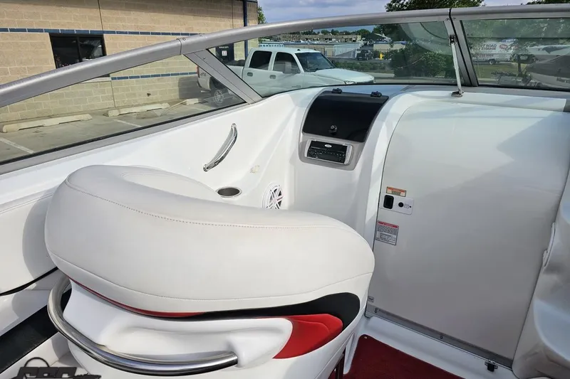 Slide: The Image of Interior of a 2004 Baja 275 boat with white seating and dashboard controls. - 50