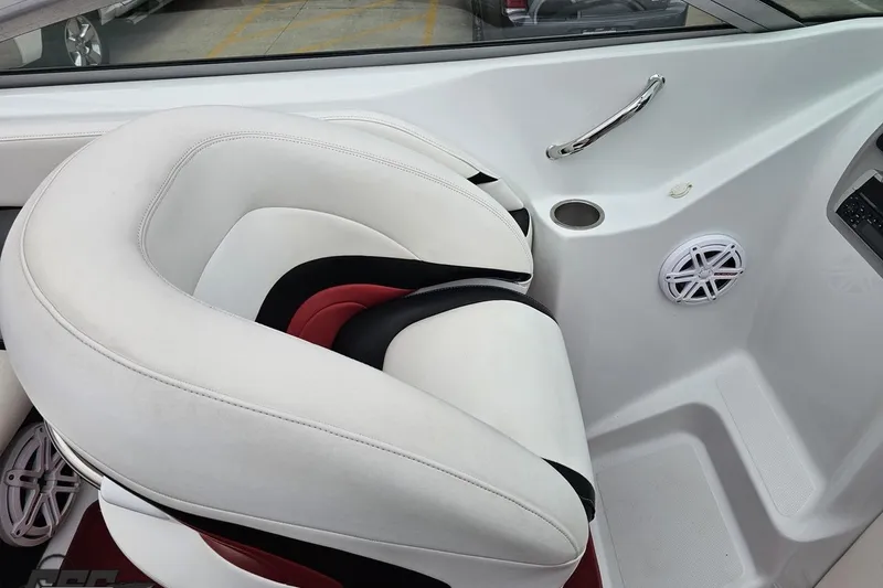 Slide: The Image of Interior of a 2004 Baja 275 boat featuring white and red seating with speaker and cup holder. - 51
