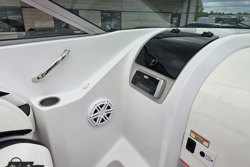 Slide: The Image of Interior of a 2004 Baja 275 boat featuring a sleek dashboard and audio system. - 52