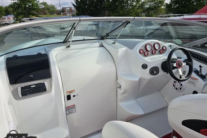 Slide: The Image of 2004 Baja 275 boat cockpit with steering wheel and instrument panel. - 53