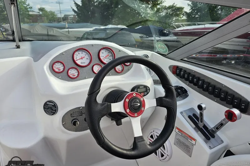 Slide: The Image of 2004 Baja 275 boat dashboard with steering wheel and control panel. - 55