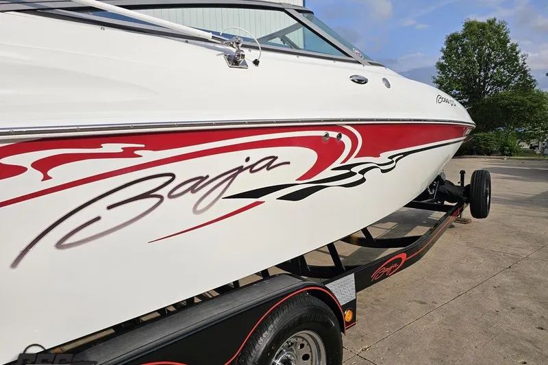 Slide: The Image of 2004 Baja 275 boat with red and black graphics on a trailer. - 6