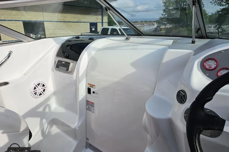 Slide: The Image of 2004 Baja 275 boat interior with dashboard, steering wheel, and audio system. - 60