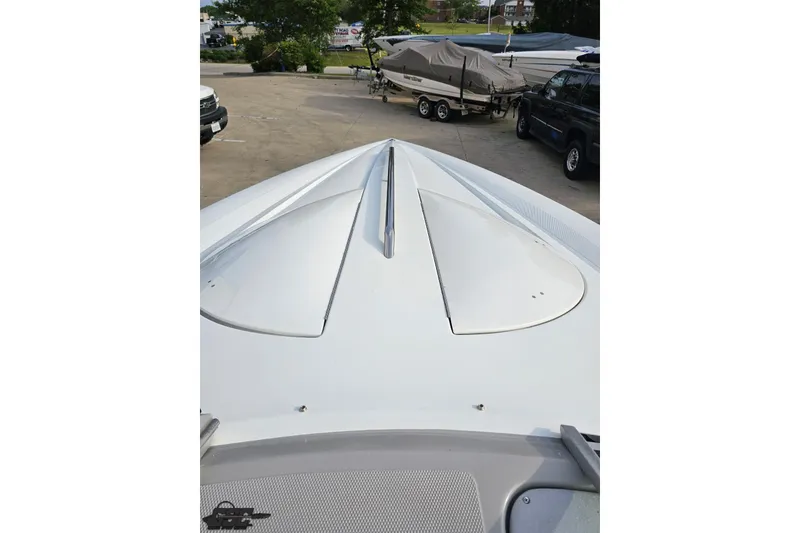 Slide: The Image of Bow view of a 2004 Baja 275 boat in a parking lot. - 62