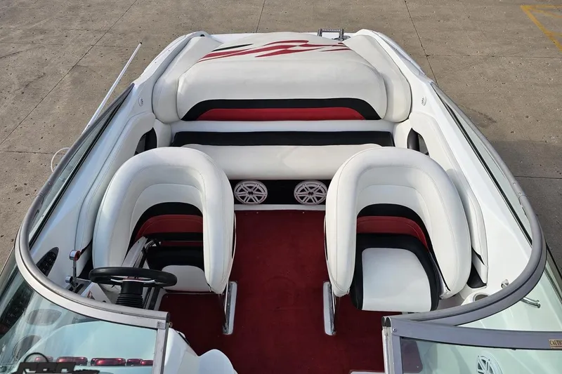 Slide: The Image of 2004 Baja 275 boat interior with white and red seating, steering wheel, and speakers. - 64