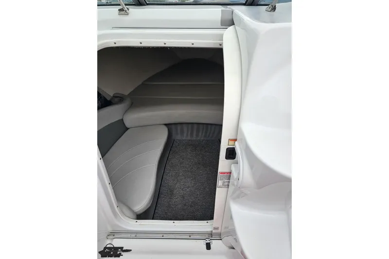 Slide: The Image of Interior cabin of a 2004 Baja 275 boat with gray seating and carpet. - 66