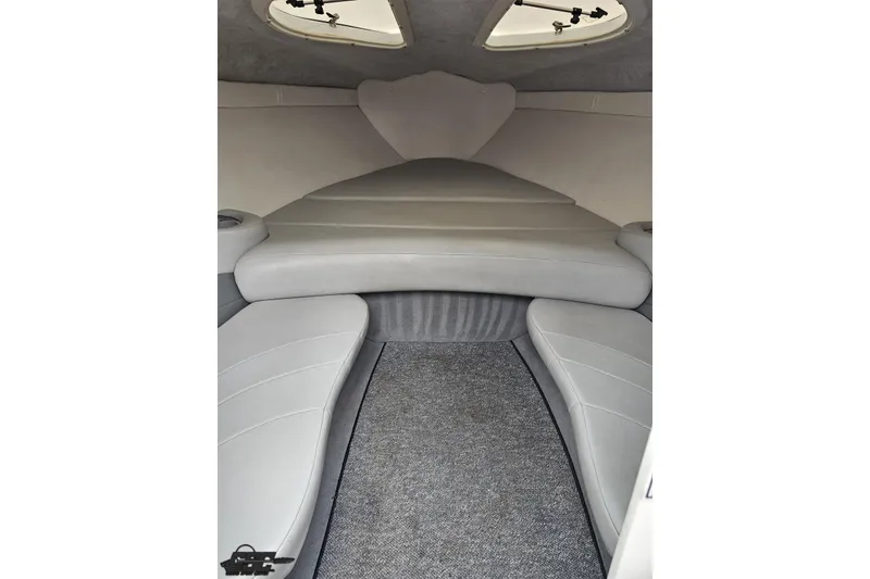 Slide: The Image of Interior cabin of a 2004 Baja 275 boat with gray seating and carpet. - 68