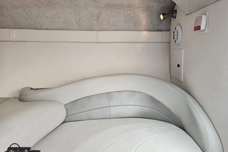 Slide: The Image of 2004 Baja 275 boat interior with white cushioned seating and ambient lighting. - 71