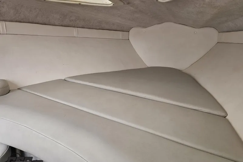 Slide: The Image of Interior cabin of a 2004 Baja 275 boat with white upholstery. - 72