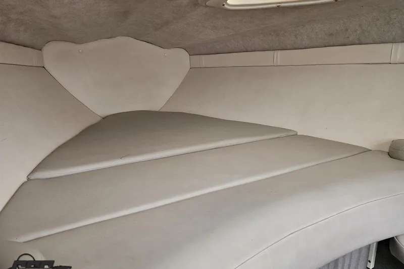 Slide: The Image of Interior cabin of a 2004 Baja 275 boat with white upholstery. - 74