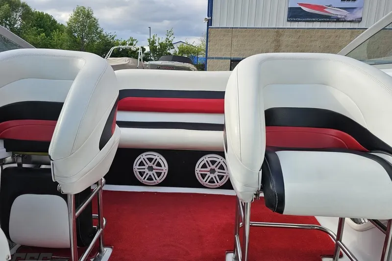 Slide: The Image of Interior of a 2004 Baja 275 boat with white, red, and black seating. - 77
