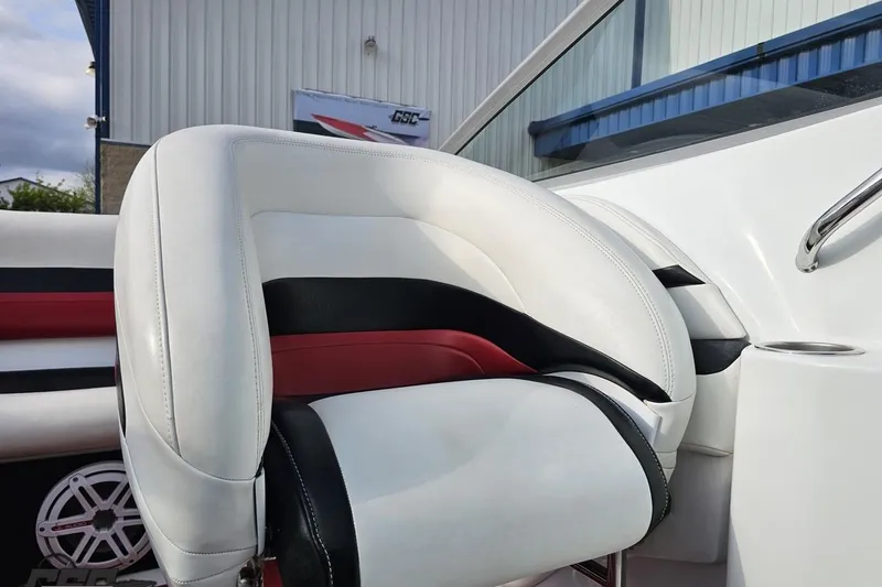 Slide: The Image of White and red interior of a 2004 Baja 275 boat, featuring sleek seating design. - 78