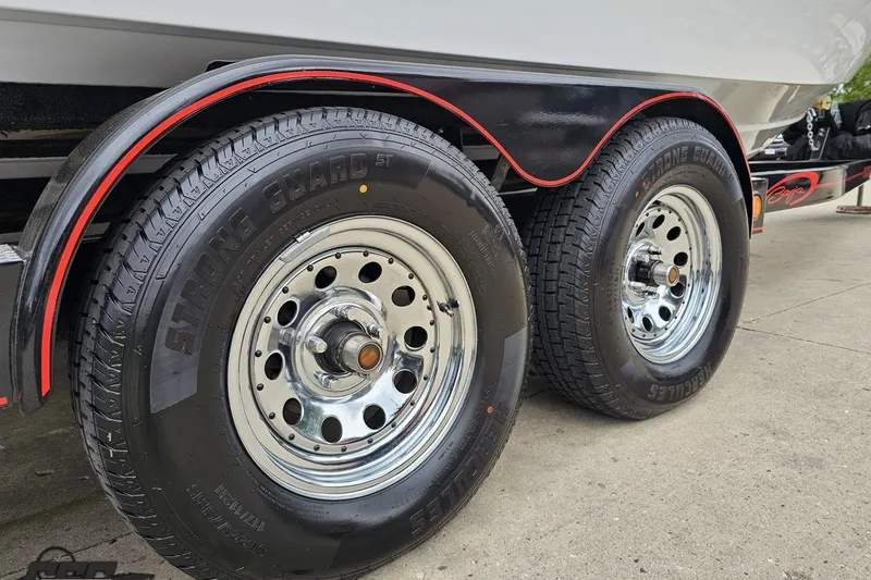 Slide: The Image of Close-up of 2004 Baja 275 trailer wheels with chrome rims and Strong Guard tires. - 8