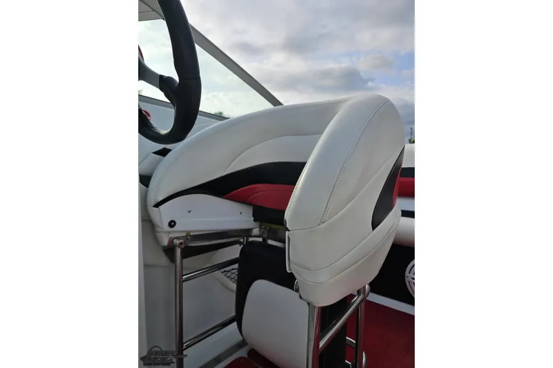 Slide: The Image of 2004 Baja 275 boat interior with white and red seating, steering wheel visible. - 80
