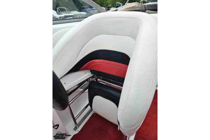 Slide: The Image of White and red boat seat in a 2004 Baja 275, featuring sleek design and comfortable padding. - 81
