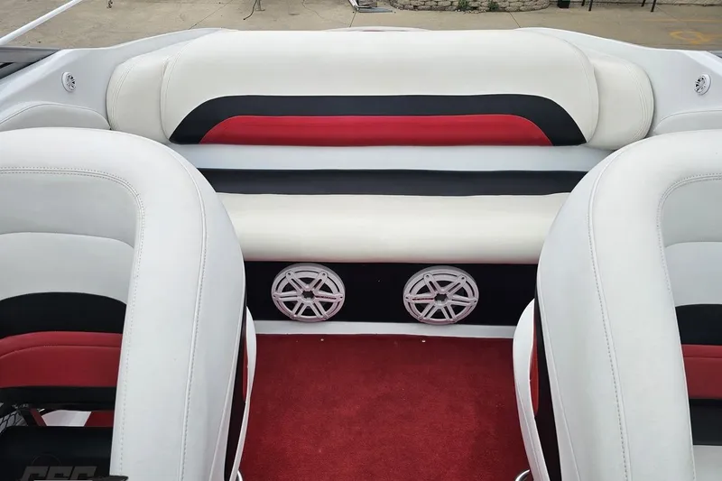 Slide: The Image of 2004 Baja 275 boat interior with red, black, and white seating and speakers. - 82