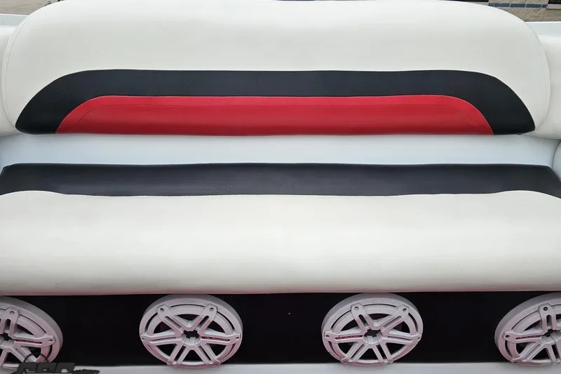Slide: The Image of Upholstered boat seating with red, black, and white design, featuring three circular speakers. - 84