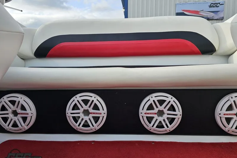 Slide: The Image of 2004 Baja 275 boat interior with red and black seating, JL Audio speakers. - 85