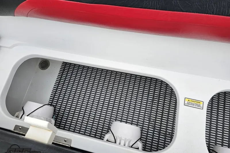 Slide: The Image of Interior view of a 2004 Baja 275 boat compartment with caution label. - 88