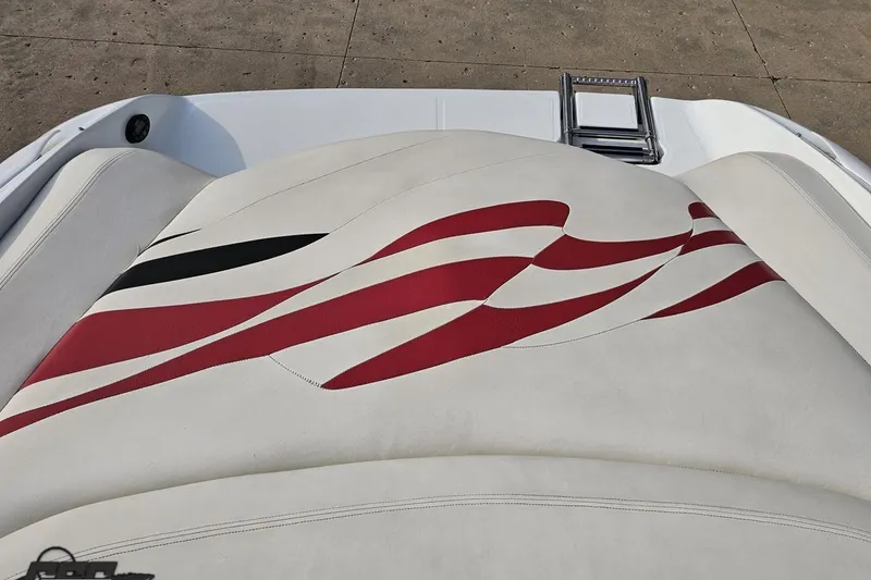 Slide: The Image of 2004 Baja 275 boat seat with red and black wave design on white upholstery. - 90