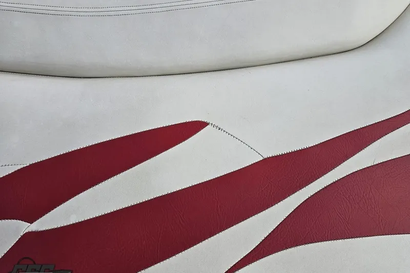 Slide: The Image of Red and white leather upholstery detail in a 2004 Baja 275 boat. - 97