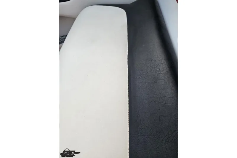 Slide: The Image of Black and white leather seating in a 2004 Baja 275 boat interior. - 99