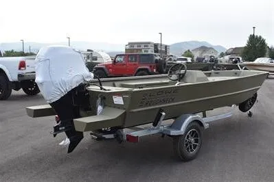 The Image of 2025 Lowe Roughneck 1860 Rambler boat on trailer, parked outdoors with vehicles in background. - 0