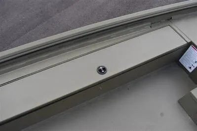 Slide: The Image of 2025 Lowe Roughneck 1860 Rambler boat interior detail with storage compartment. - 11
