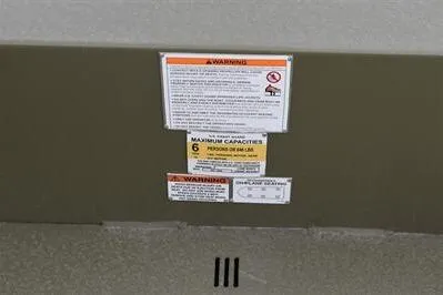 Slide: The Image of Warning and capacity labels on 2025 Lowe Roughneck 1860 Rambler boat. - 15