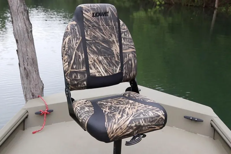 Slide: The Image of Manufacturer Provided Image: Camouflage seat on 2025 Lowe Roughneck 1860 Rambler boat by a lake. - 21