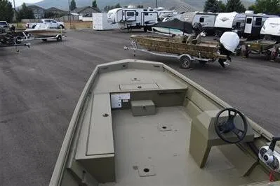 Slide: The Image of 2025 Lowe Roughneck 1860 Rambler boat in a parking lot with trailers and RVs. - 6