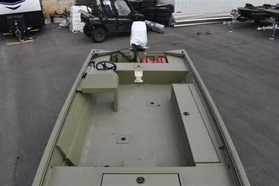 Slide: The Image of 2025 Lowe Roughneck 1860 Rambler boat, olive green, parked outdoors, showcasing spacious interior layout. - 7
