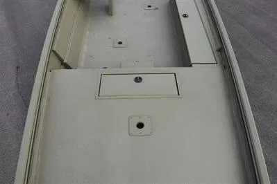 Slide: The Image of 2025 Lowe Roughneck 1860 Rambler boat interior with storage compartments. - 8