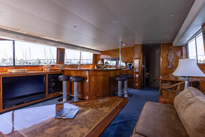 Slide: The Image of Luxurious 1988 Donzi yacht interior with wooden bar, stools, and plush seating. - 12