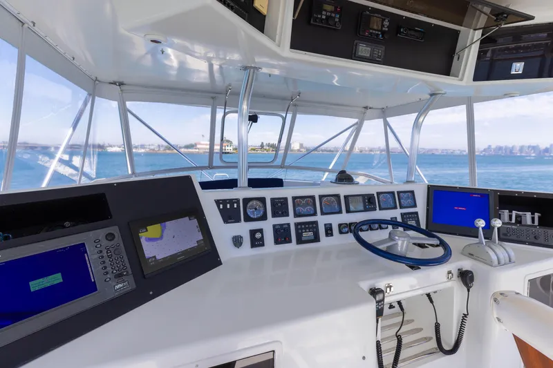 Slide: The Image of Cockpit of a 1988 Donzi boat with navigation equipment and ocean view. - 7