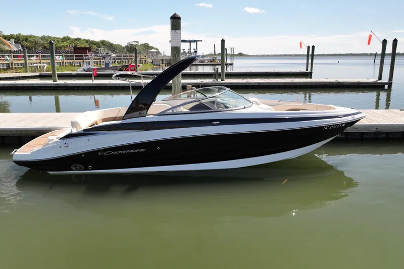 Slide: The Image of 2017 Crownline 275 SS boat docked at a marina on a sunny day. - 1